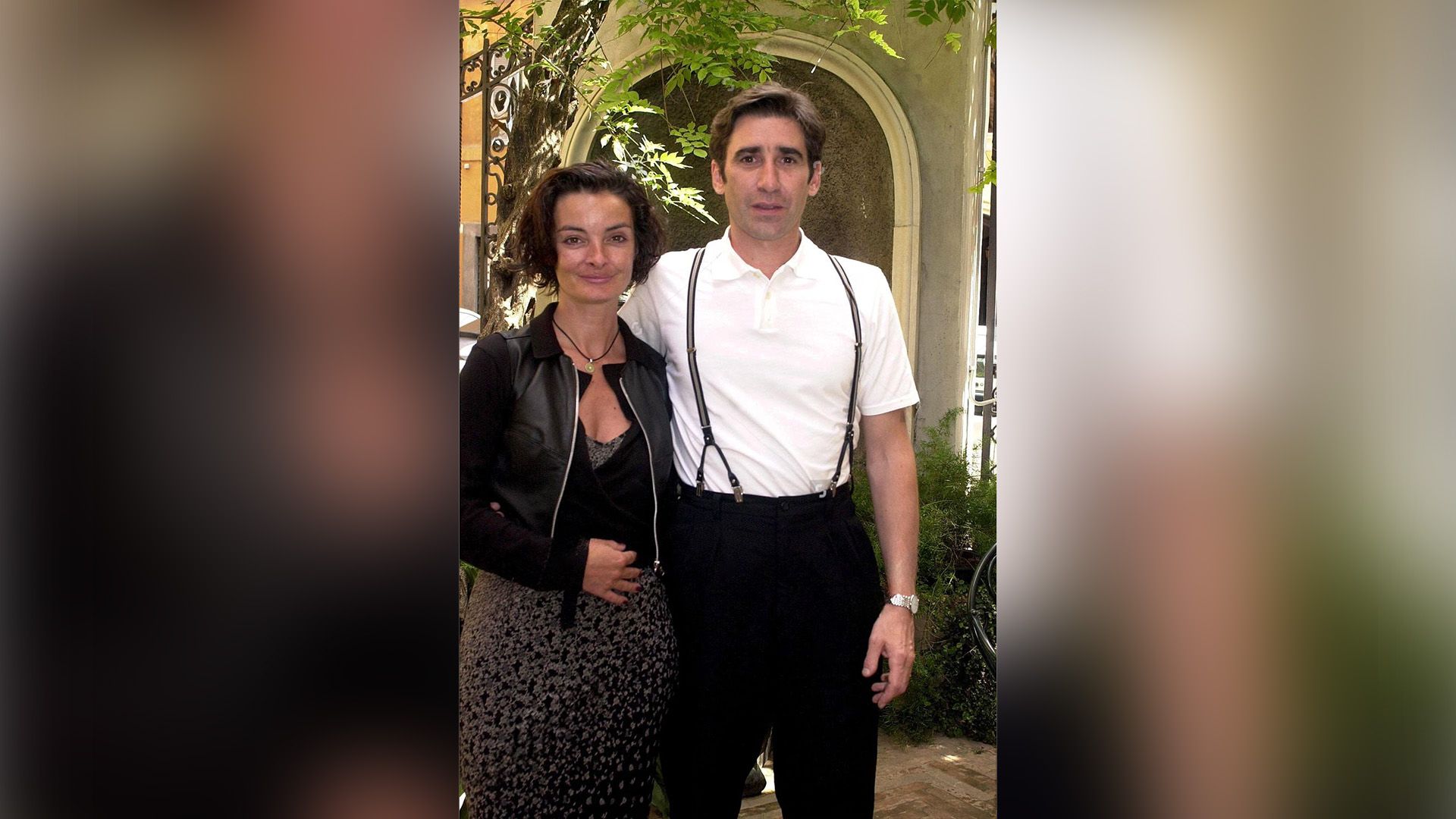 Mary McGuckian num vestido preto e John Lynch numa camisa branca e suspensórios