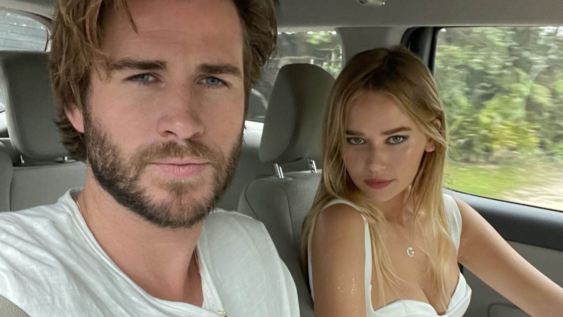 Liam Hemsworth e Gabriella Brooks a tirar uma selfie no carro