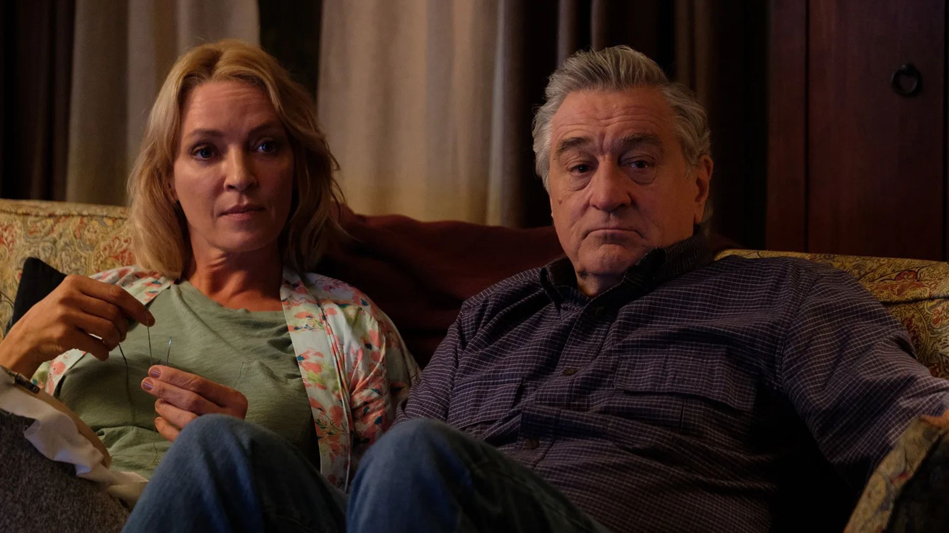 Uma Thurman e Robert De Niro sentados num sofá, cena do filme